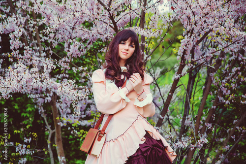 Beautiful girl in a vintage dress. Spring flowers. Lolita style. Victorian style. © Amina