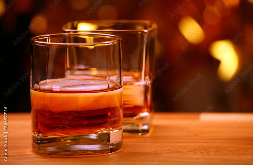 ice whiskey glass gold bokeh 