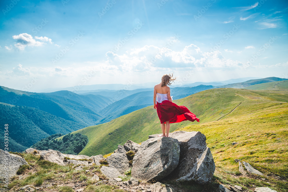 Obraz premium Young woman on the top of mountain