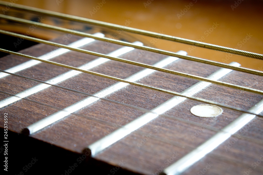 Fragment of an acoustic guitar - closeup shot Fragment of an acoustic guitar - closeup shot