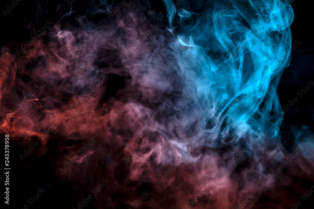 The exhaled column of vapor illuminated with blue and pink light evaporates in thin streams against a black background as it clumps into smoke.