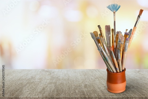 Brushes in a glass jar on desk