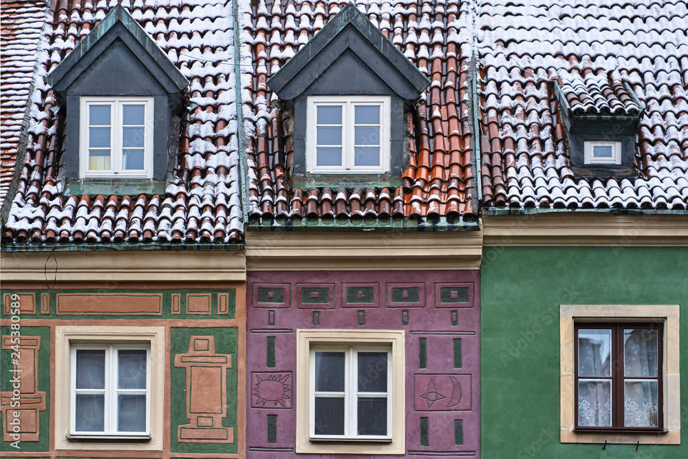 Fragment of the facade of historic tenement houses in the winter on the market square in Poznan.