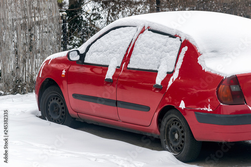 the red car is covered with snow © Andrzej Płotnikow