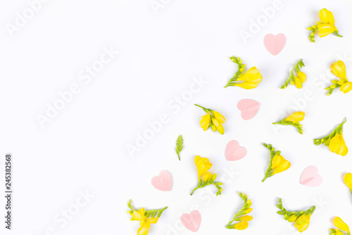 Valentines Day and Mother Day background. Floral pattern made of yellow flowers on white background. Flat lay, top view