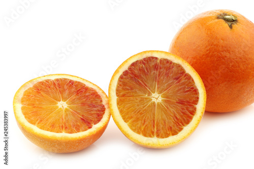 fresh blood orange and a cut one on a white background