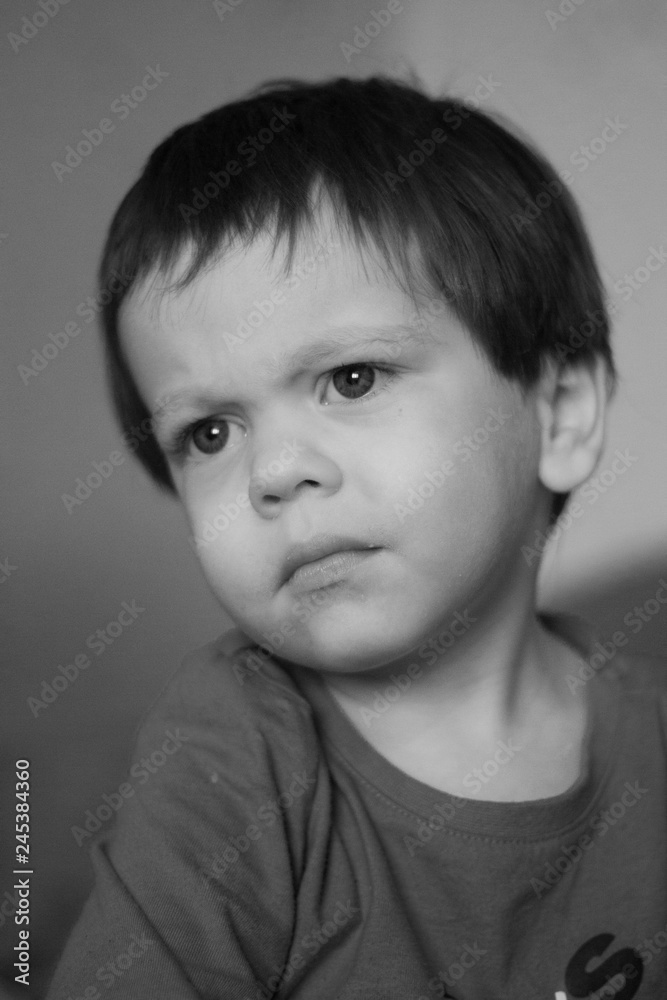 Black and white portrait of a boy. Little boy portrait. Black and white portrait of a boy. Little boy portrait.
