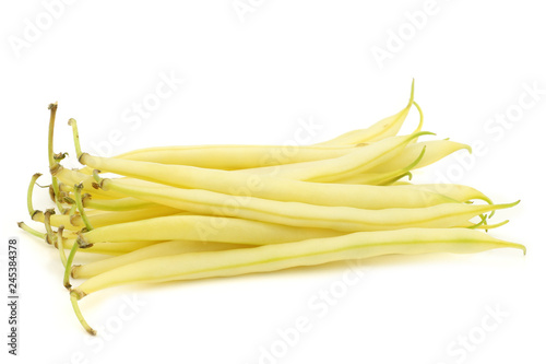 Bunch of yellow wax beans on a white background