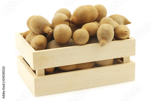 Tamarind beans in a wooden box on a white background