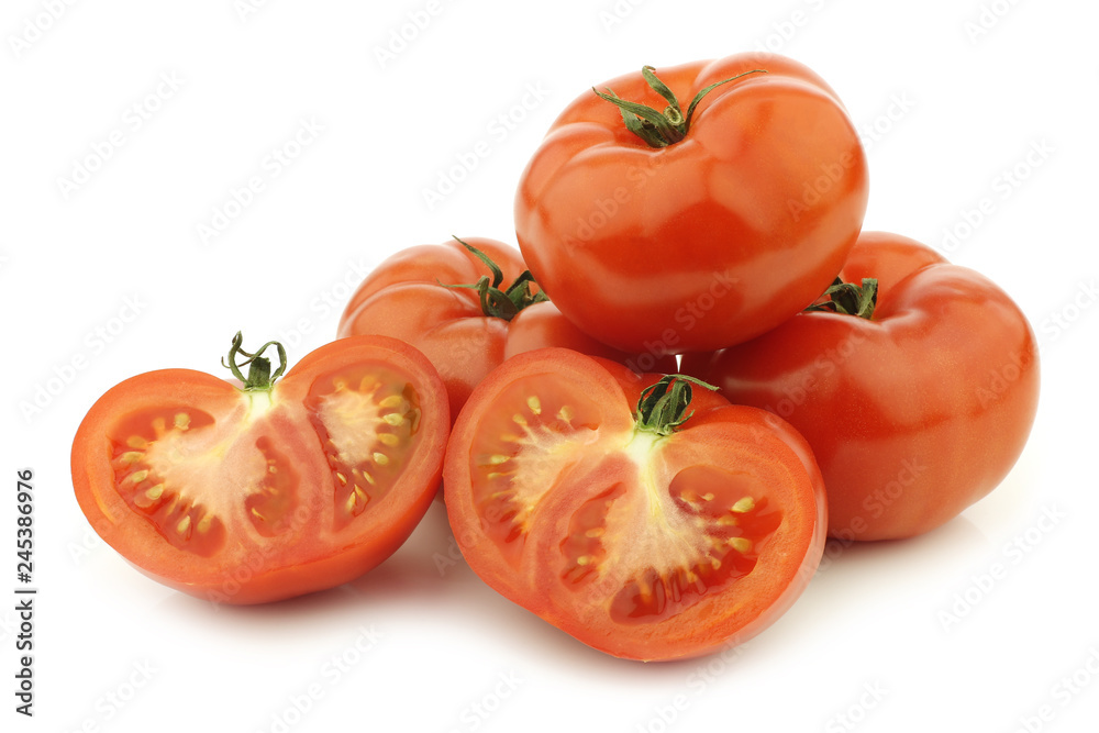 fresh beef tomatoes and a cut one on a white background fresh beef tomatoes and a cut one on a white background