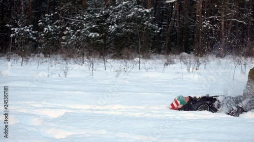 Man walks in the snow, slips and falls smoothly moving into slow motion