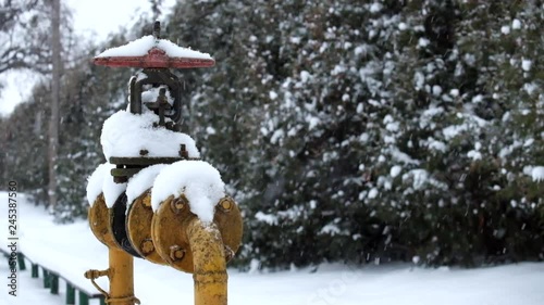 Old butterfly gas valve in heavy snow