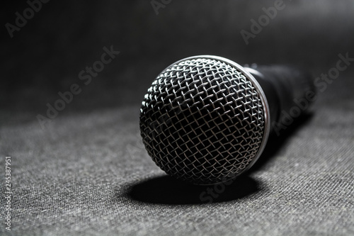 The electric microphone on a monophonic black background. Equipment for the singer or blogger. Music. Technologies.