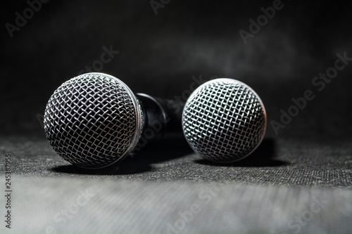 The electric microphone on a monophonic black background. Equipment for the singer or blogger. Music. Technologies.