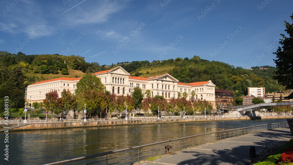 The building of the University of Deusto next to the river in. Bilbao on a sunny day