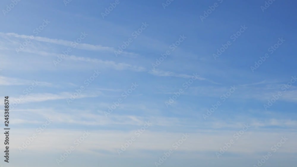 Wispy Clouds With Small Jet Contrails Streaking Across Sky Wispy Clouds With Small Jet Contrails Streaking Across Sky