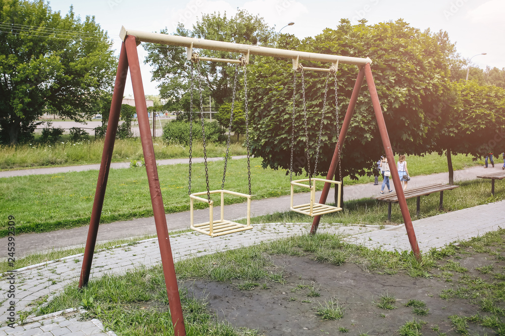 Two swings on children playground. Outdoors games for kids.