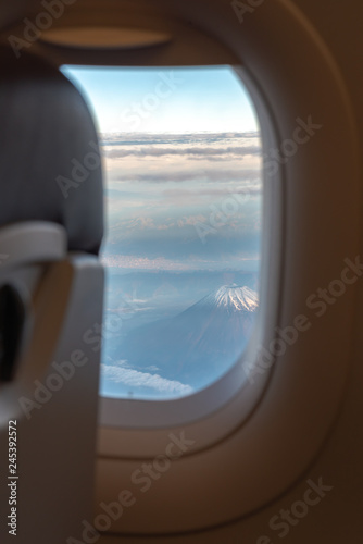 View form airplane window. Mount Fuji ( Mt. Fuji ) with blue sky and cloud in background. Tokyo, Japan