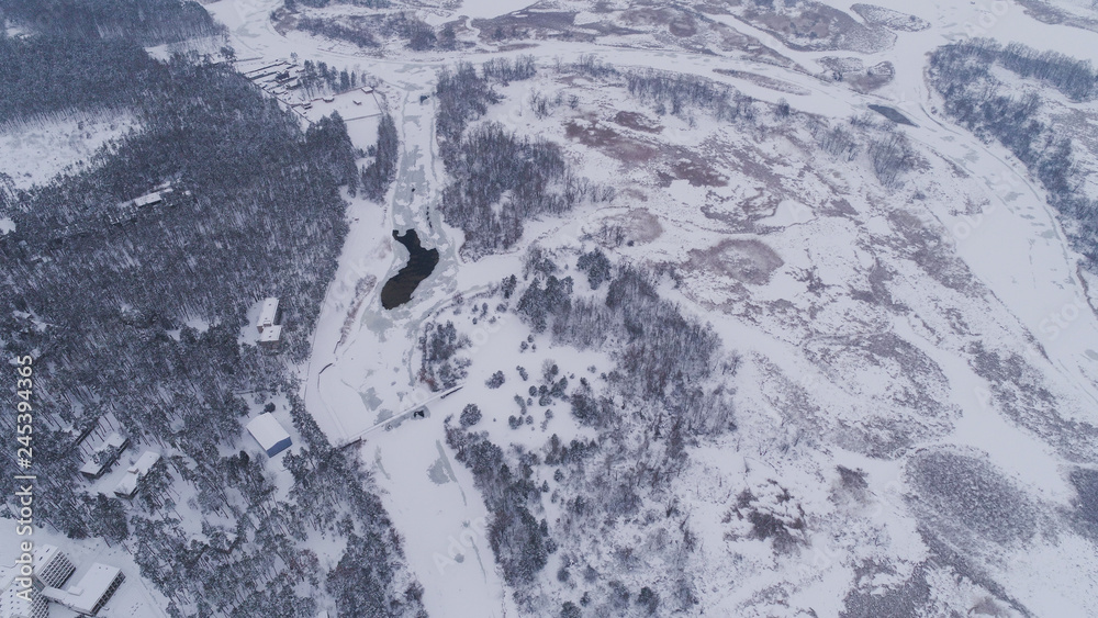 Obraz Frozen river and forest in snow view Fromm 500 meter , drone shoot ,areal photo