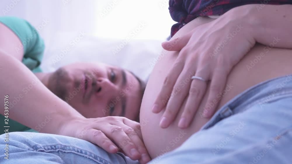 Pregnant couple caressing pregnant belly. Mom and dad hands on pregnant tummy. Maternity concept. Pregnancy. Happy family. Pregnant couple caressing pregnant belly. Mom and dad hands on pregnant tummy. Maternity concept. Pregnancy. Happy family.