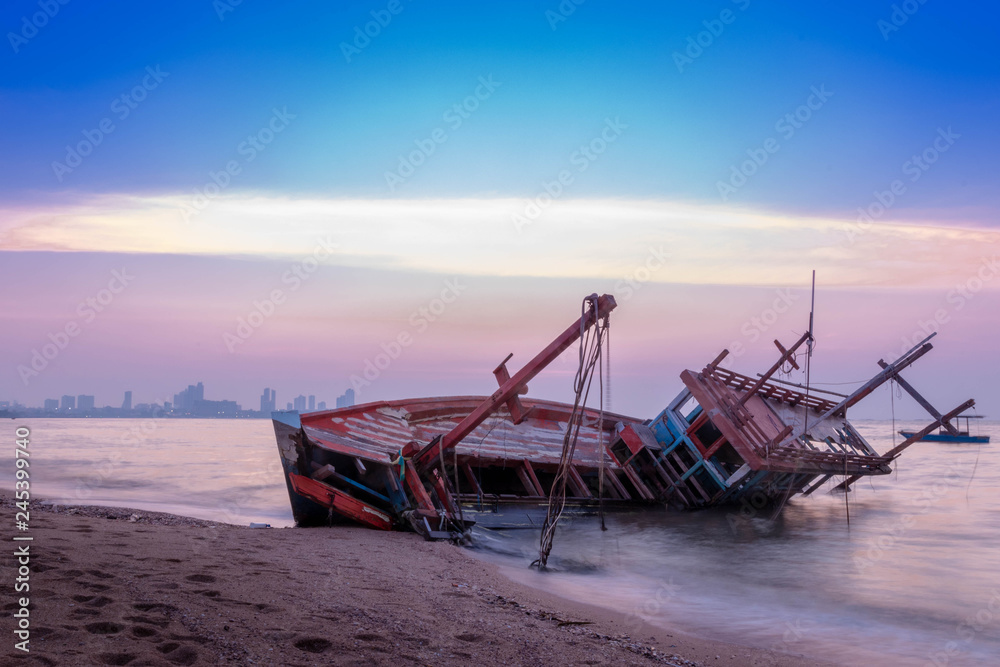 Fishing boat wrecks on the beach Sunset