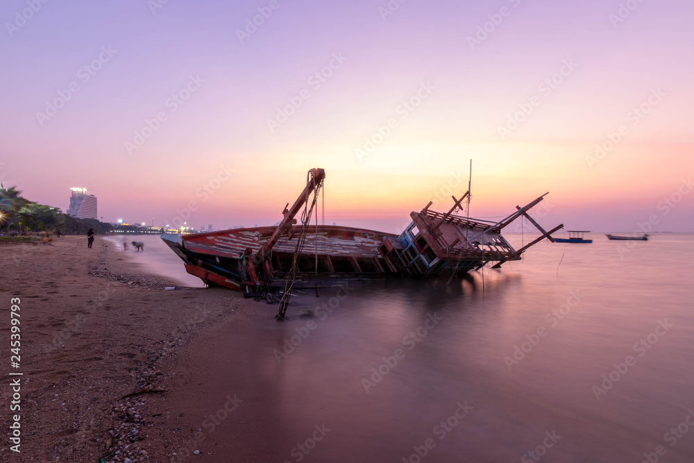 Fishing boat wrecks on the beach Sunset