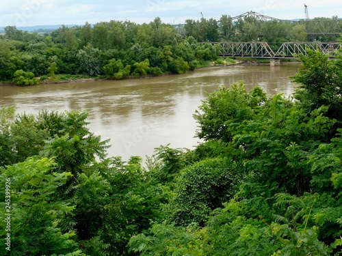 Missouri River Summer Landscape of the Mighty Big Muddy Mo and Riverbank Trees With Trestle Bridge in Atchison Kansas photo
