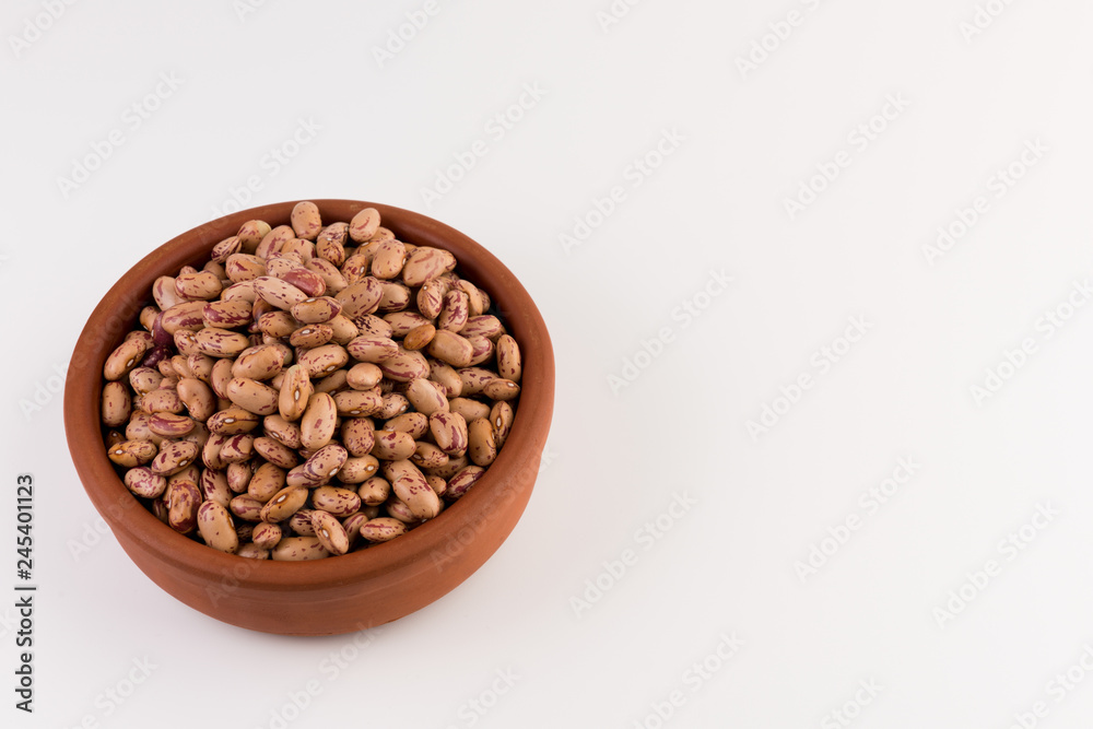 A plate of beans on white background