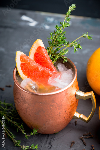 Photography Grapefruit moscow mule in copper mug on the rustic background