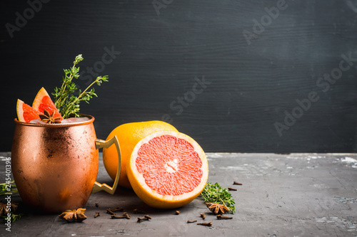 Photography Grapefruit moscow mule in copper mug on the rustic background