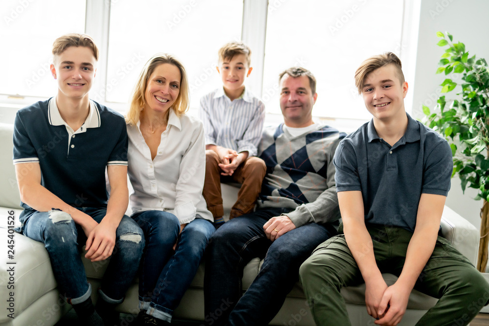 A Beautiful happy family sit on sofa at home A Beautiful happy family sit on sofa at home