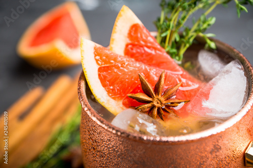 Canvas Print Grapefruit moscow mule in copper mug on the rustic background