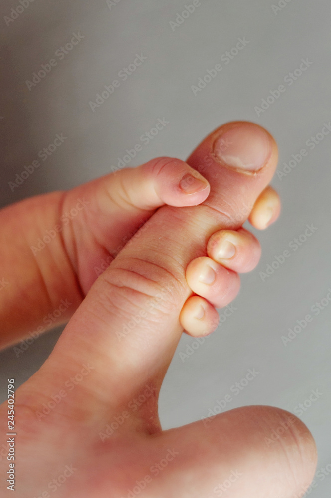 Newborn baby holds dad by the finger with a small hand. Father and him Child. Happy Family concept. Newborn baby holds dad by the finger with a small hand. Father and him Child. Happy Family concept.