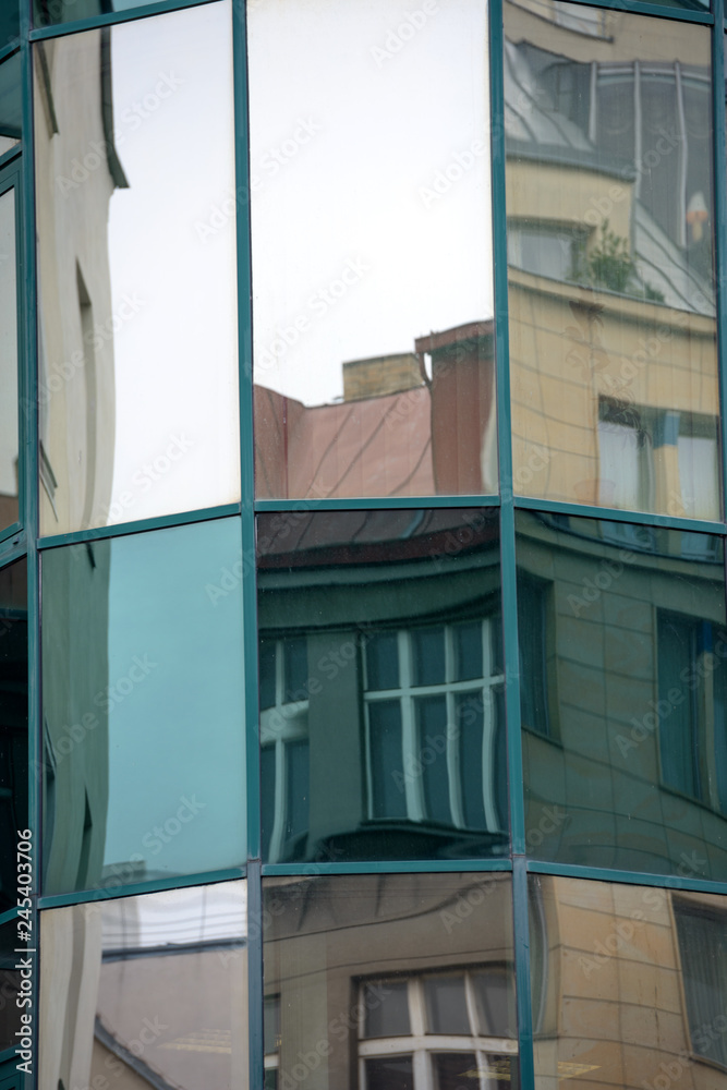 Close-up reflections in modern glass facade in Prague, Czech Republic.
