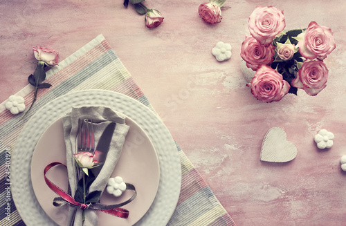 Valentine's day table setup, top view on light pink background