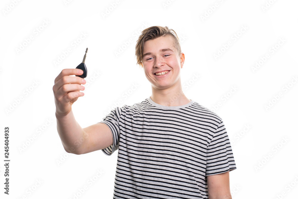 A teenager holding the key of his first car