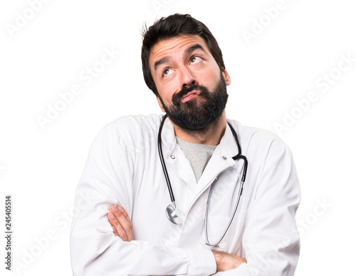 Young doctor making unimportant gesture on white background