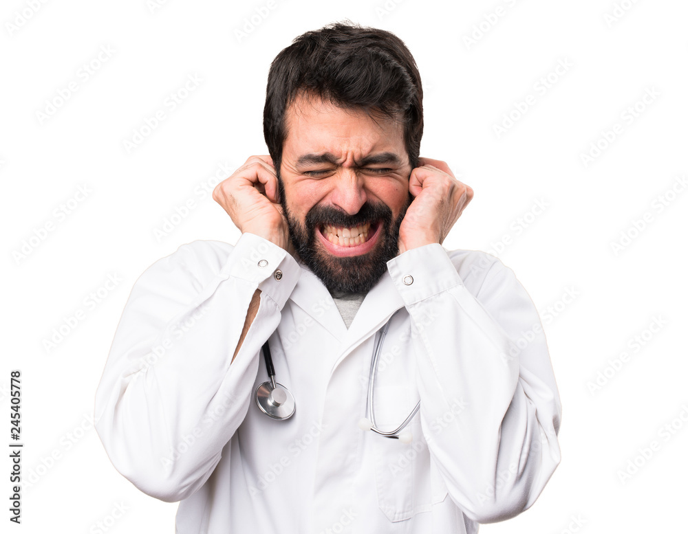 Young doctor covering his ears on white background Young doctor covering his ears on white background