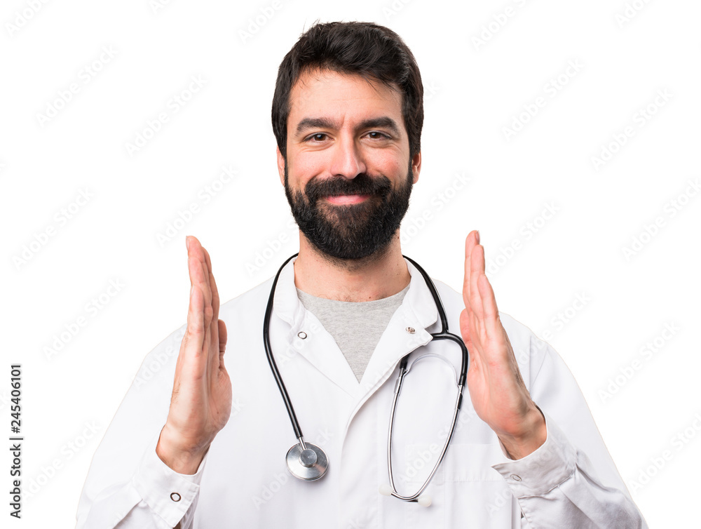 Young doctor holding something on white background Young doctor holding something on white background