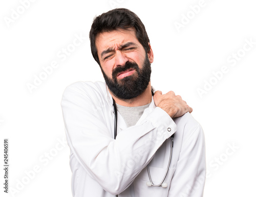 Young doctor with shoulder pain on white background © luismolinero
