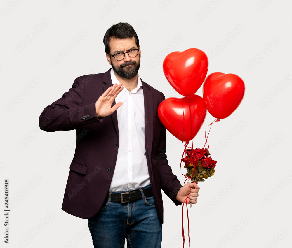 Man in valentine day making stop gesture with her hand to stop an act over isolated grey background Man in valentine day making stop gesture with her hand to stop an act over isolated grey background