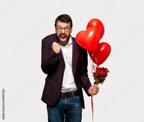 Man in valentine day frustrated by a bad situation over isolated grey background © luismolinero