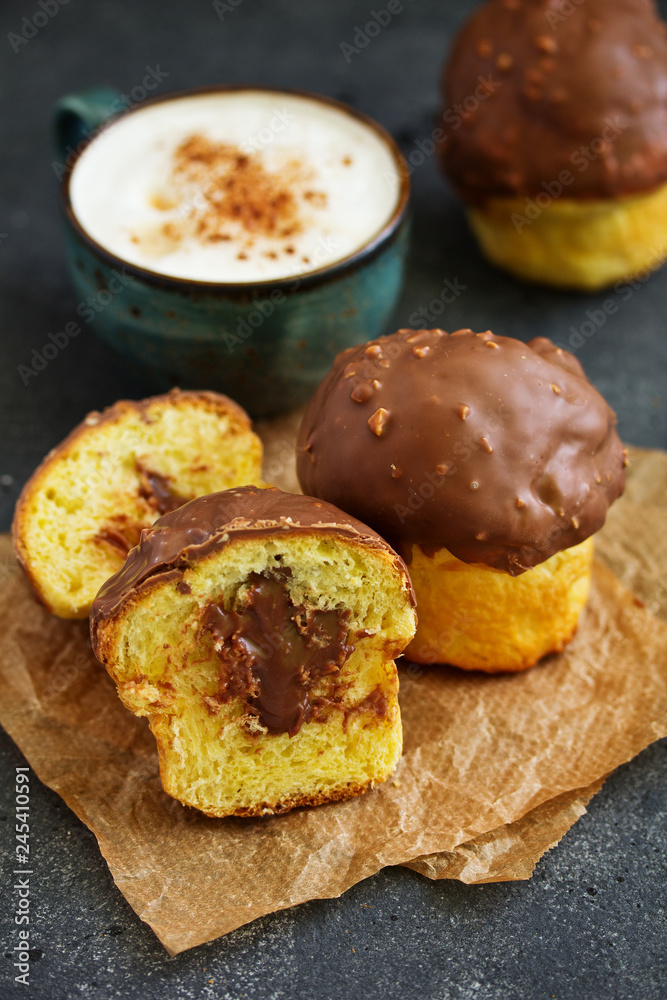 Brioche bun with chocolate filling and chocolate coating. Brioche bun with chocolate filling and chocolate coating.