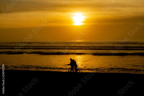 Sunset over main beach in Agadir Morocco showing silhouettes and reflections