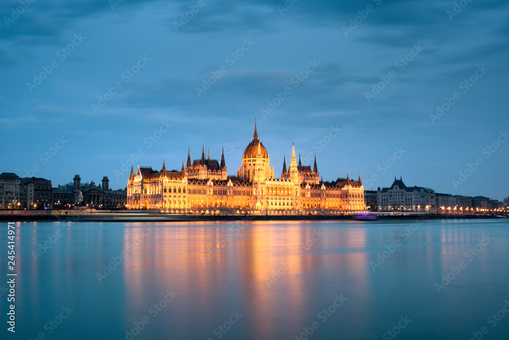 Budapest waterfront featuring spotlighted Parliament building