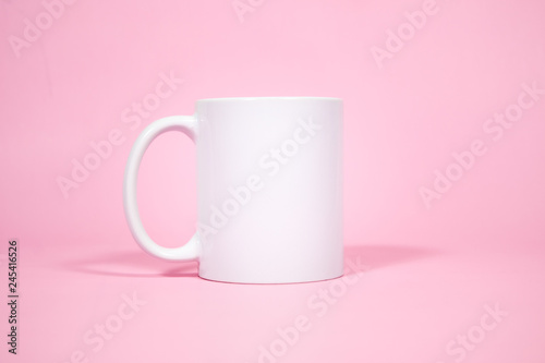 White coffe mugs on pink background  photo