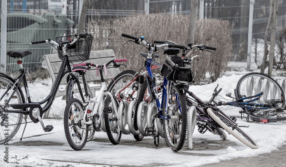 Bikes left in parking slots during winter days, waiting for better time