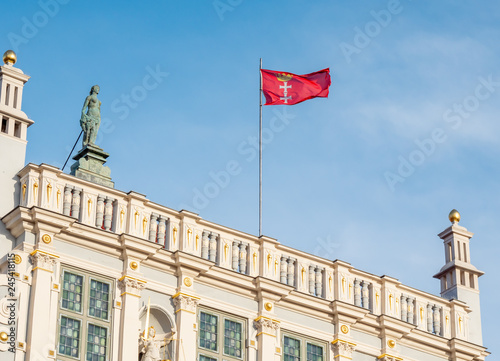 Gdansk, Poland, city flag, sign of Gdansk, on top of old building - Artus Court.