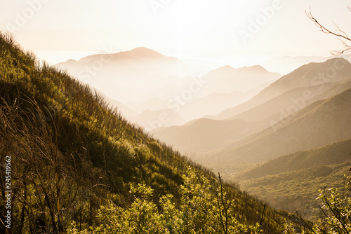 Dramatic mountain valley at sunset with ridges and layers