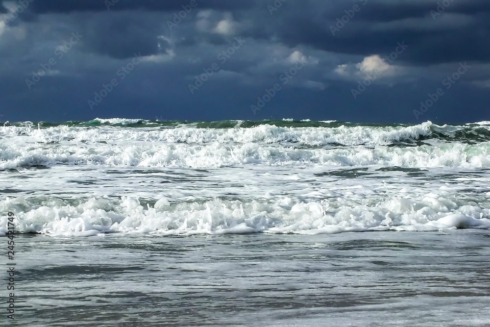 Fototapeta premium Autumn storm. Waves & foam under dramatic sky